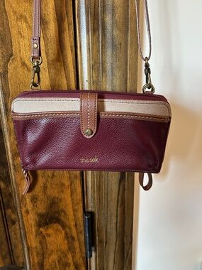 The Sak Burgundy Crossbody Wallet with Tan Trim and Cream Accent